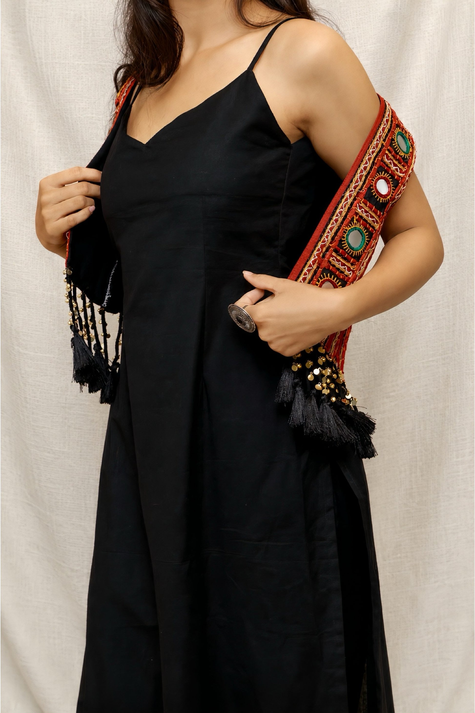 Model wearing the Anaykaa Zariya Kutchi Mirrorwork Jacket Kurta Set in premium black Cotton featuring a handcrafted Kutchi mirrorwork embroidered jacket with tassels and matching straight pants.