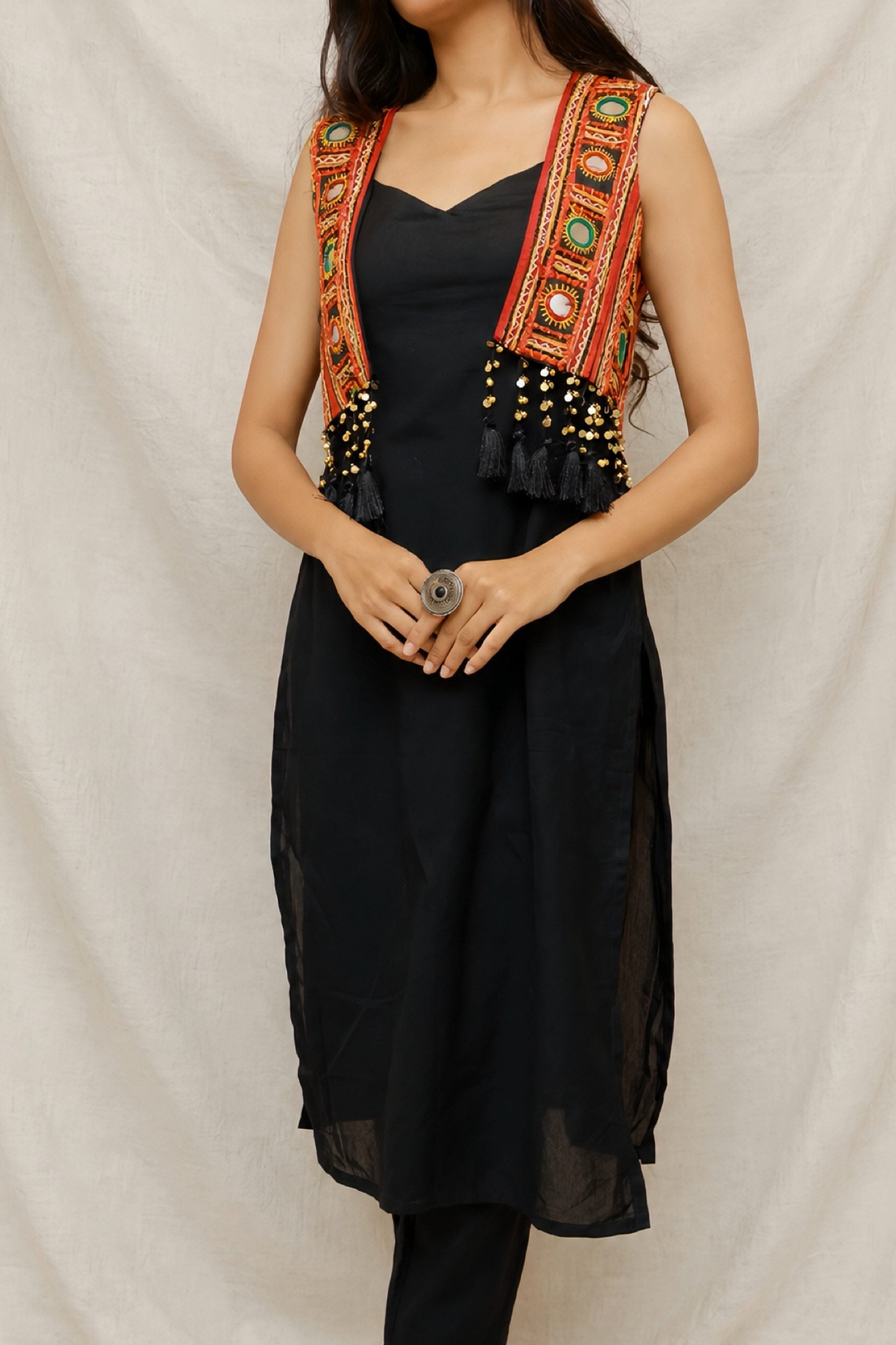 Model wearing the Anaykaa Zariya Kutchi Mirrorwork Jacket Kurta Set in premium black Cotton featuring a handcrafted Kutchi mirrorwork embroidered jacket with tassels and matching straight pants.