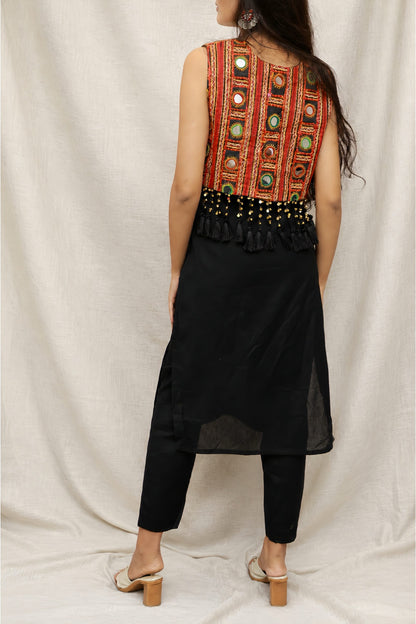 Model wearing the Anaykaa Zariya Kutchi Mirrorwork Jacket Kurta Set in premium black Cotton featuring a handcrafted Kutchi mirrorwork embroidered jacket with tassels and matching straight pants.
