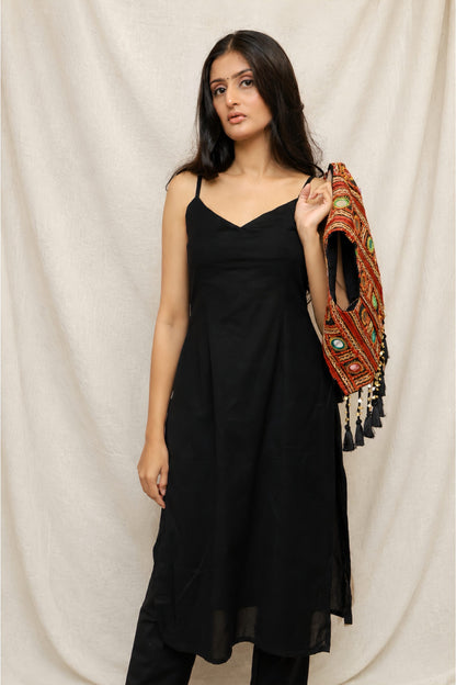 Model wearing the Anaykaa Zariya Kutchi Mirrorwork Jacket Kurta Set in premium black Cotton featuring a handcrafted Kutchi mirrorwork embroidered jacket with tassels and matching straight pants.