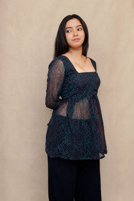 Model wearing the Reya Bandhani Co-ord Set in navy blue premium georgette featuring a Bandhani print peplum top with sheer bell sleeves and matching wide-leg pants.
