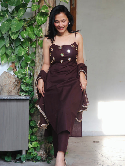 Woman wearing the Shya Brown Cotton Kurta Set in breathable cotton featuring elegant mirror detailing, matching pants, and dupatta by Anaykaa.