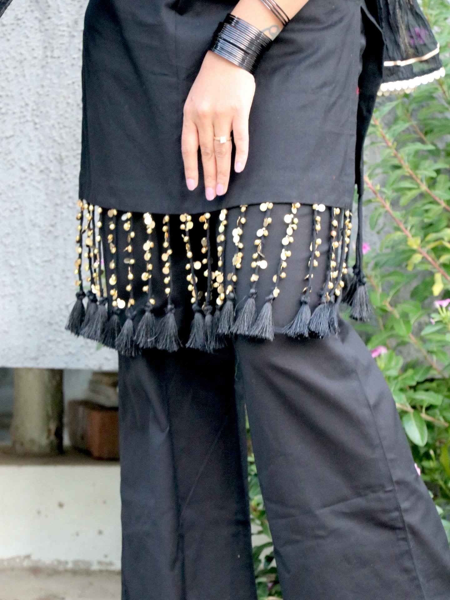 Woman wearing the Tisya Black Suit Set featuring an elegant black kurta, matching bottoms, and coordinated dupatta by Anaykaa.