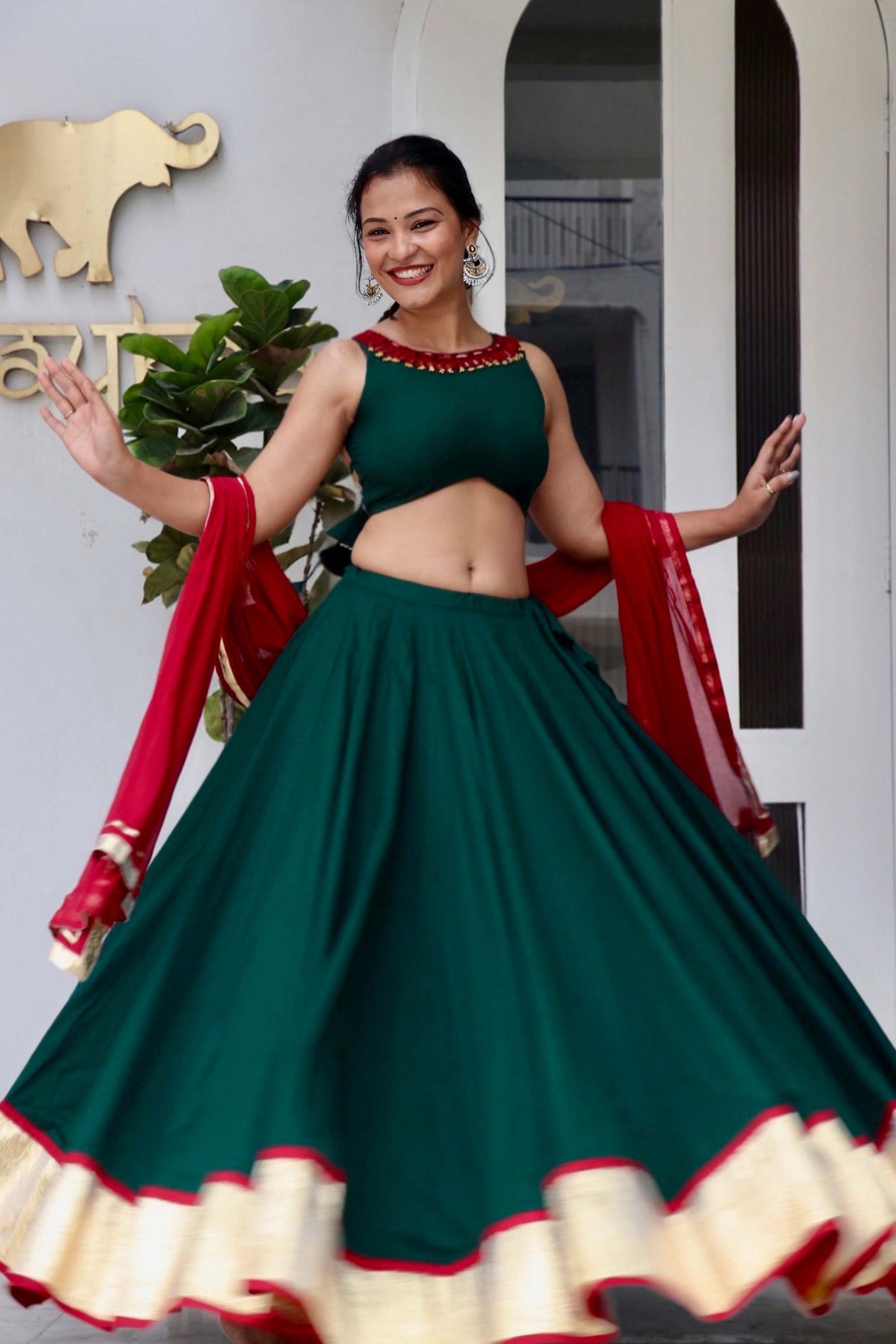Trisha green cotton Navratri chaniya choli with hand and mirror work and maroon dupatta by Anaykaa
