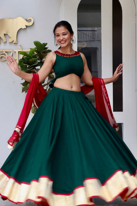 Trisha green cotton Navratri chaniya choli with hand and mirror work and maroon dupatta by Anaykaa