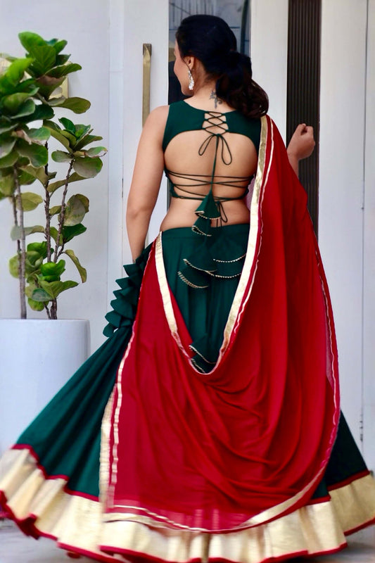 Trisha green cotton Navratri chaniya choli with hand and mirror work and maroon dupatta by Anaykaa